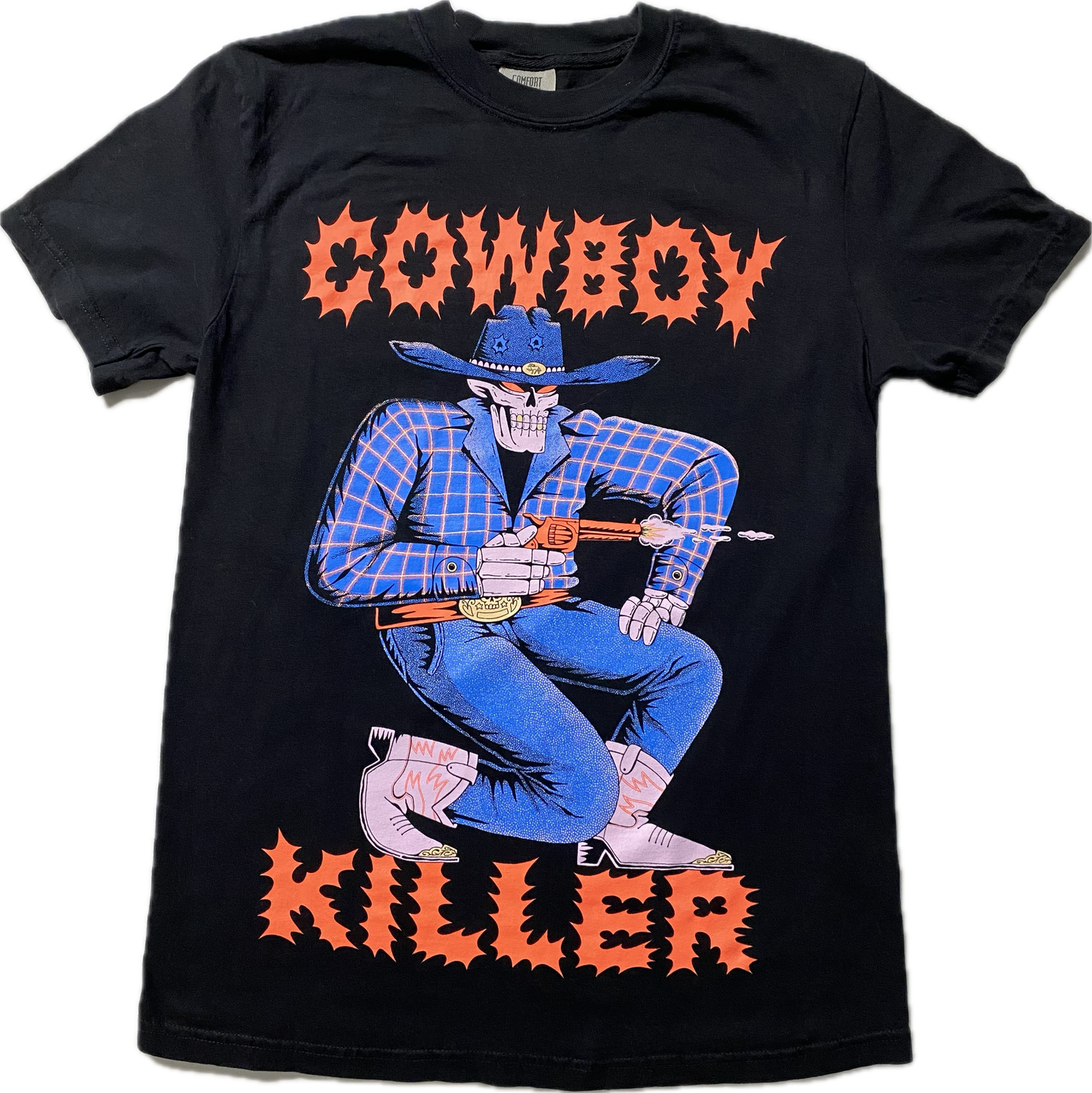 A black short sleeve t-shirt with the word Cowboy at the top and Killer at the bottom in a spikey font. Between the words is a cartoon skeleton in blue cowboy attire and pink boots.