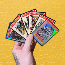 Load image into Gallery viewer, A hand holding 6 Flash Friends set 2 trading cards created by Crocodile Jackson.  Two of the cards are holographic.  The background is yellow.