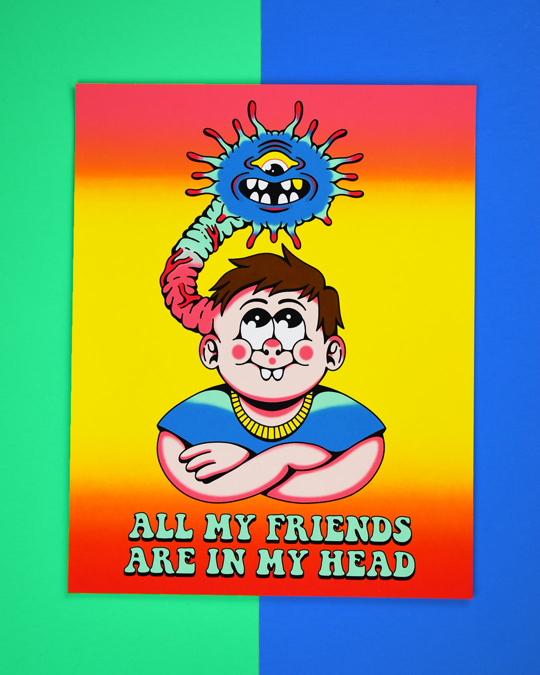 Poster that reads All My Friends Are in My Head. It has a brown haired kid with rosy chubby cheeks and 2 large front teeth, wearing a blue t-shirt and the kids arms are crossed. From the left side of his head a monster is coming out and over the kids head. The monster is blue with one eye and open mouth with eight teeth and antennas all around its face.