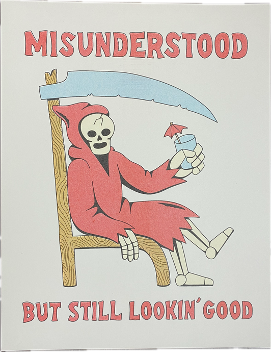 Poster with Misunderstood written at the top in red font and But Still Lookin' Good at the bottom.  In the middle is a red cloaked skeleton sitting on a chair made from a sickle toasting with a glass in its left hand.  There is a small umbrella sticking out  of the glass.