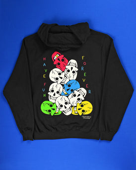 The back of a black hoodie with 9 colorful screen printed smiling skulls piled high.  On the left and written vertically is Have Fun in alternating colors of red, blue green & yellow.  On the right and also vertically is Forever in the same alternating colors per letter.