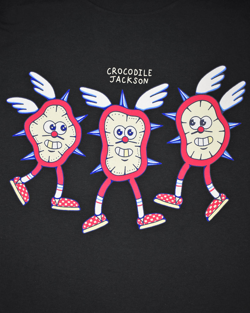A close up of 3 smiling cartoon clocks on the front that all have spikes, wings, legs and checkered tennis shoes.  Above the clocks reads Crocodile Jackson.