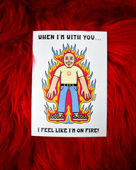 A card that reads When I'm with You...I Feel Like I'm on Fire! The center has a cartoon bald man in jeans and a t-shirt and checkered sneakers. He has one gold tooth and is surrounded by flames.
