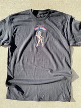 Load image into Gallery viewer, A black short sleeve t-shirt that reads Welcome to the Shit Show. The last 2 words are in a large font in rainbow colors of light blue, white and pink. Below the words is a cowgirl with blue hair in a white bathing suit and white boots. She is holding a blue lasso and have a holster with a pistol.  Background is concrete.
