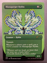 Load image into Gallery viewer, Trading card with a title at the top left that reads Managorger Hydra.  Below that is a cartoon creature with 4 heads all pointing down to a silhouette of a man in a cowboy had that is trapped in it's claws.  The creature is white with purple stripes, gold mane and black claws.  At the bottom of the card information about the creature and the game - Magic the Gathering.
