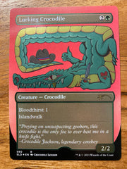 A trading card that shimmers in the light with a title of Lurking Crocodile.  Below the title is a cartoon crocodile with his tail overhead and a cowboy hat sitting on the end of it's tail.  The left arm of the crocodile is holding a knife and has a heart tattoo that reads 'Croc' on the top of it's arm.  Below the art is information on the Magic the Gathering game.