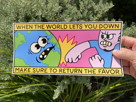 A bumper sticker that reads When the World Lets You Down Make Sure to Return the Favor at the top and bottom in black fonts with a yellow background. In the center is a cartoon globe with a face being punched by a guy with a gold tooth and wearing a blue t-shirt.  Plant in the background.